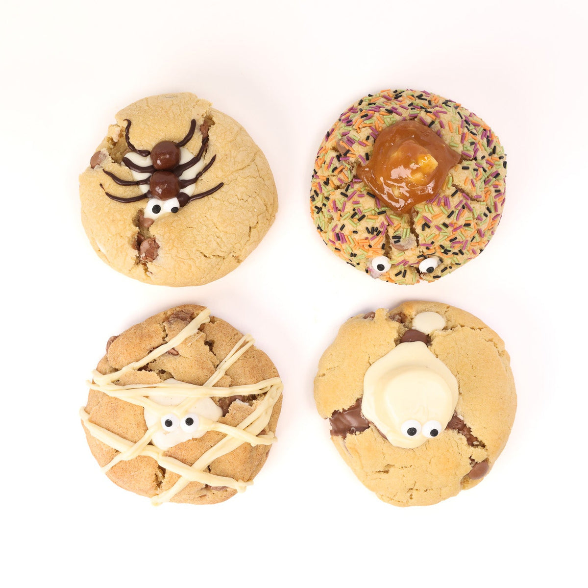 Four Halloween-themed decorated cookies arranged in a 2x2 grid on a white background. The top-left cookie is tan with a dark brown spider decoration and white eyes.