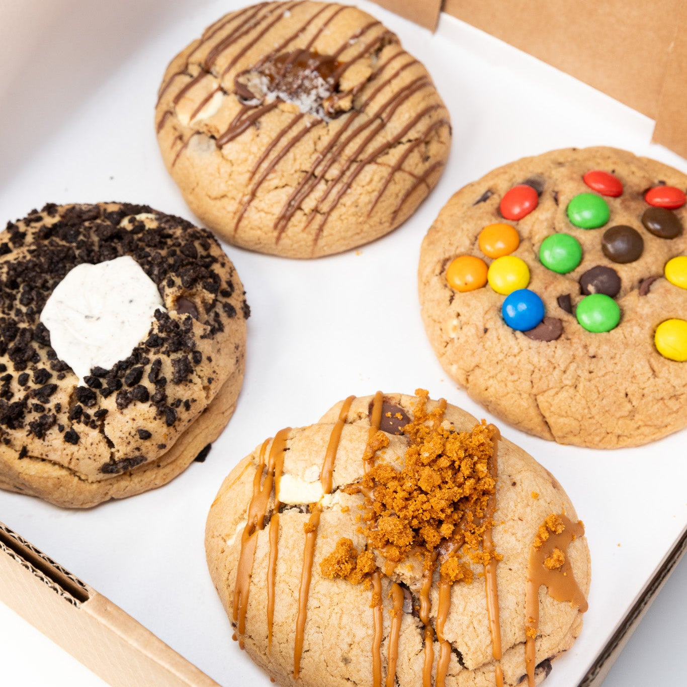 Assorted cookies in a box on a white surface